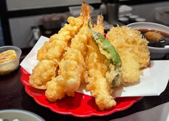 tempura shrimp and vegetables on a red plate
