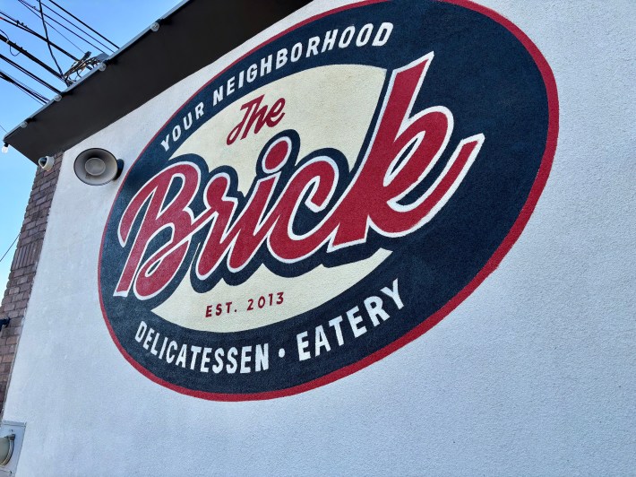 a bold logo on the wall of a building's exterior