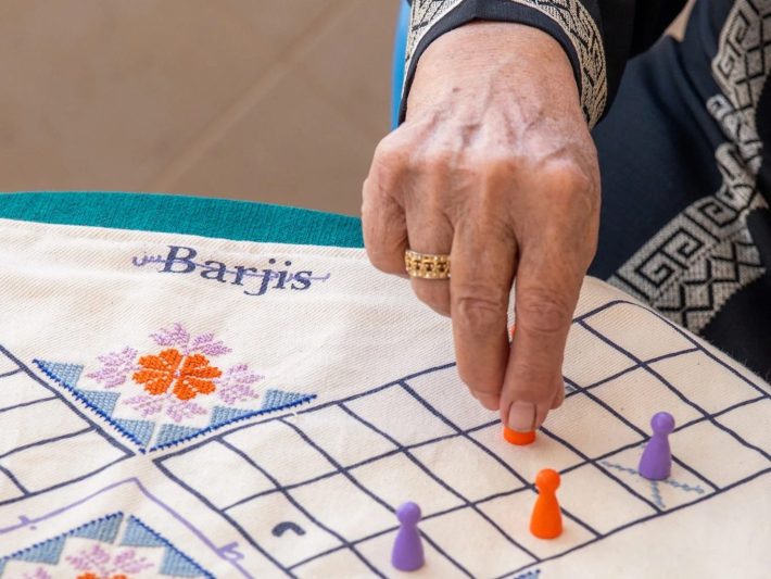 a woman's hand playing a boardgame