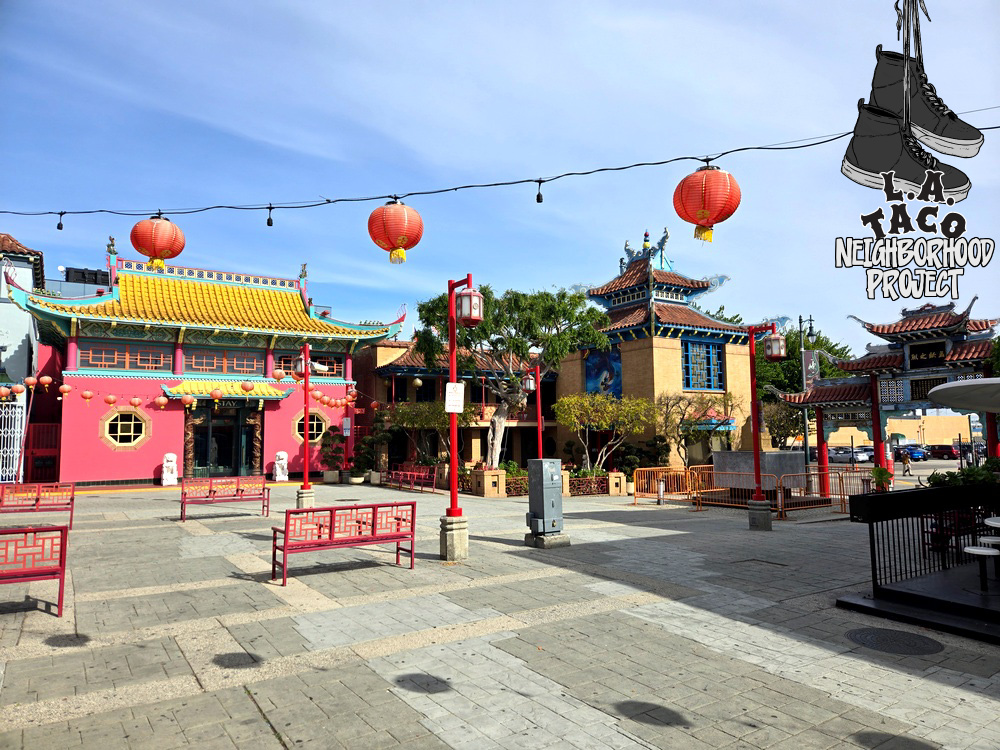 Chinatown's Central Plaza in Los Angeles, with red paper lanters strung over a wide courtyard with pagoda roofs in back.