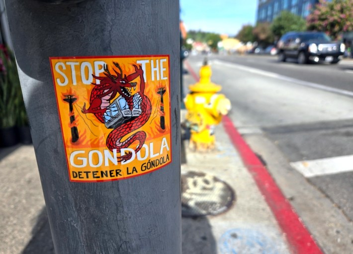 An orange sticker featuring a red Chinese dragon that says "Stop the Gondola"