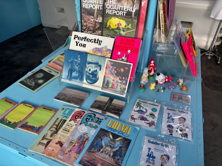 a table with various books, knick knacks and stationery items