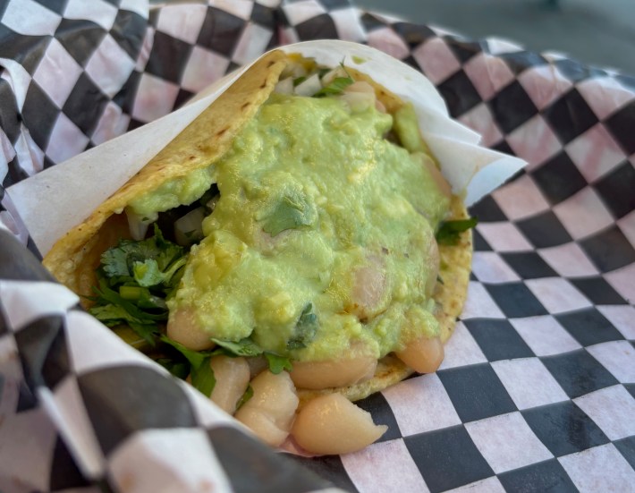a taco with beans and guacamole