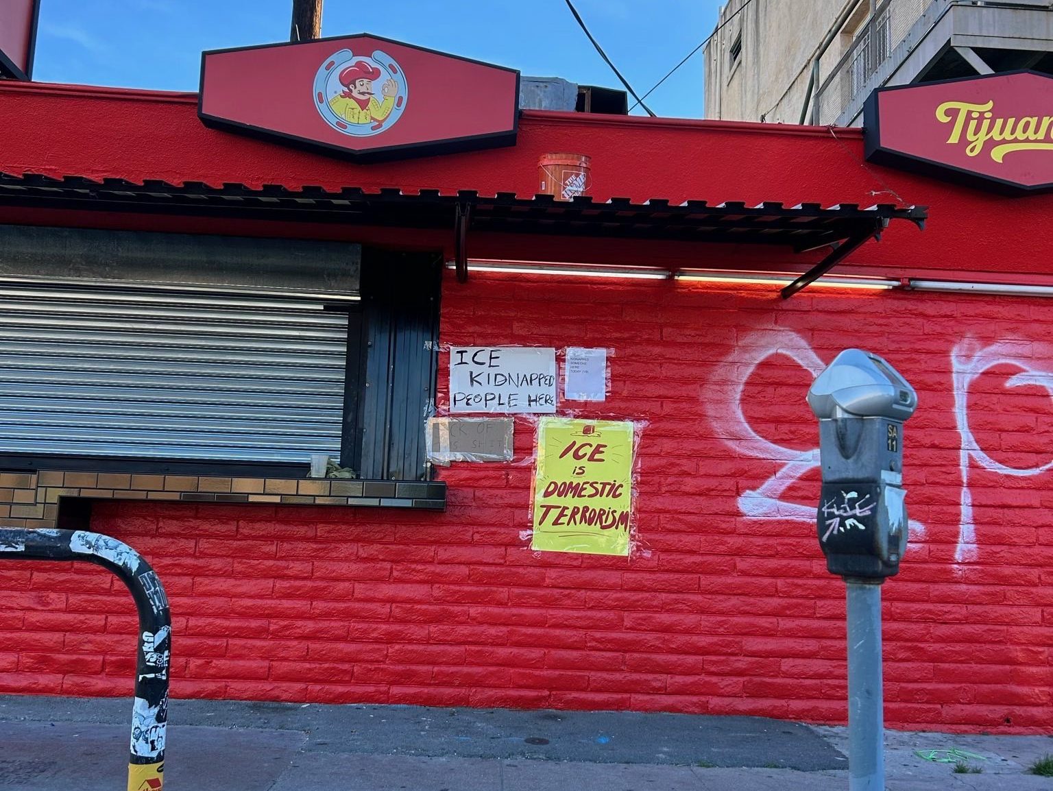 two signs on a red building