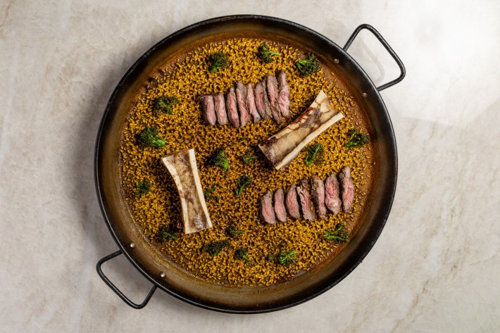 Bone marrow and wagyu paella in a black pan