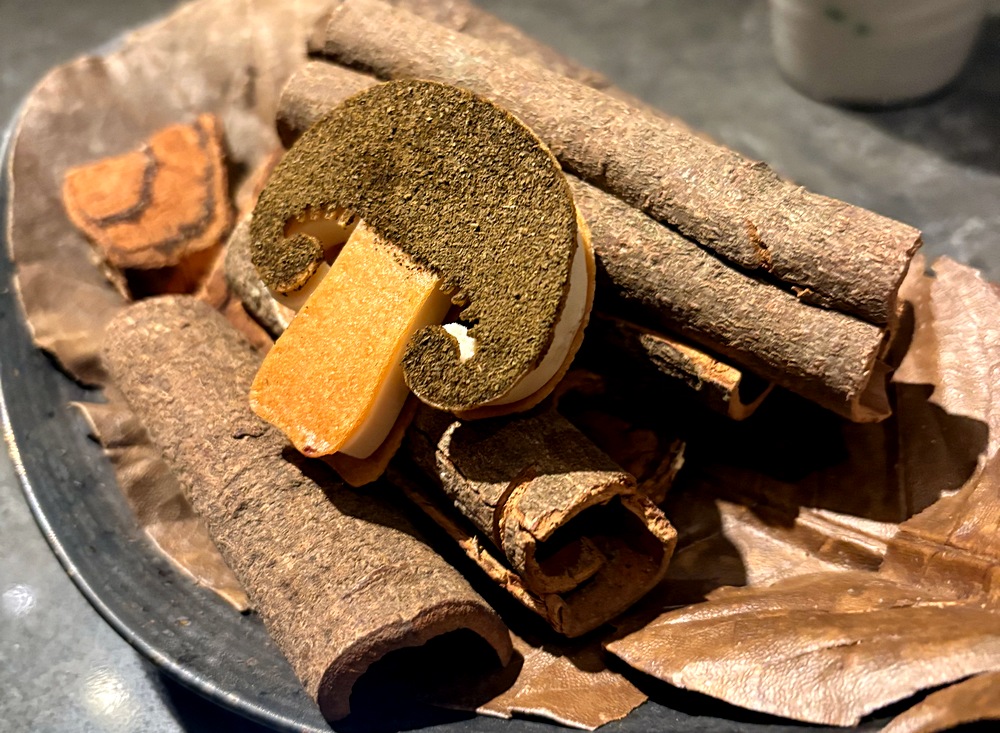 A Korean dessert on cinnamon sticks that looks like a mushroom-shaped cookie
