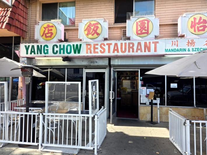 The exterior of Yang Chow restaurant with its signage in English and Mandarin.