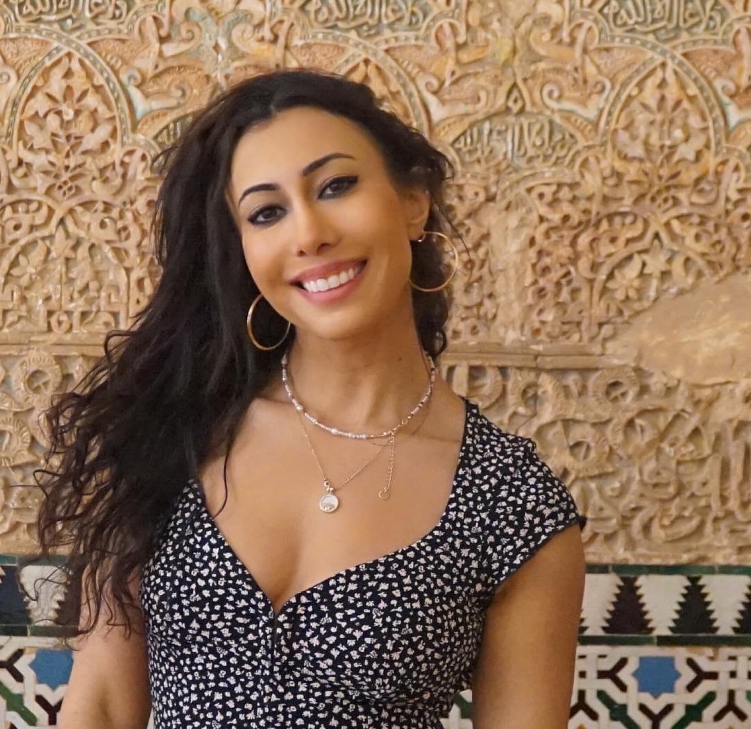 a woman smiles into the camera