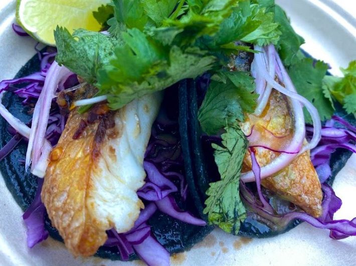 Dry-aged taco from Anajak Thai topped with cilantro and purple cabbage.