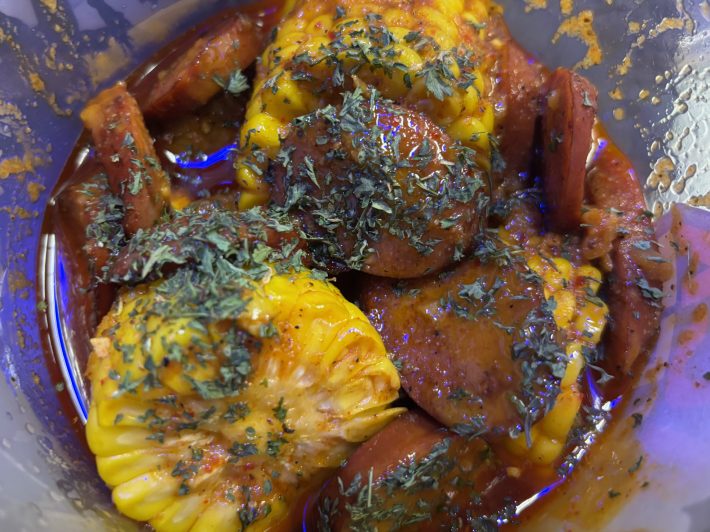 seafood boil with sausage, corn, parseley