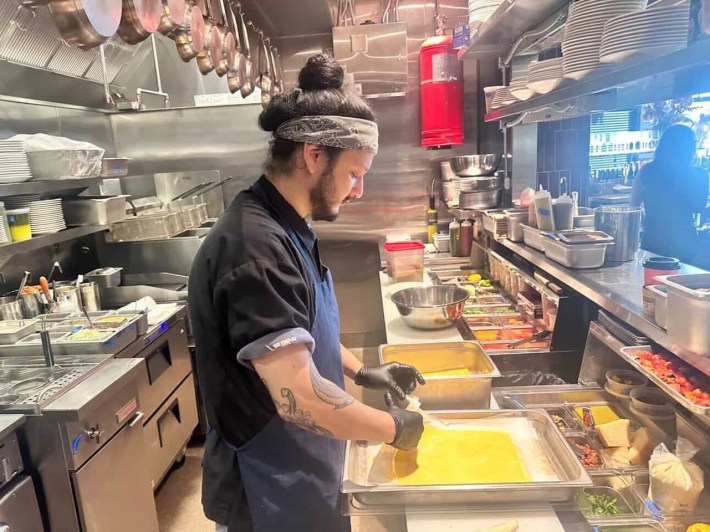 a man cooks in a professional kitchen