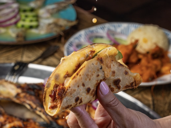 Tacos de Marlin smoked marlin from Mexico with onion, tomato & cheese.