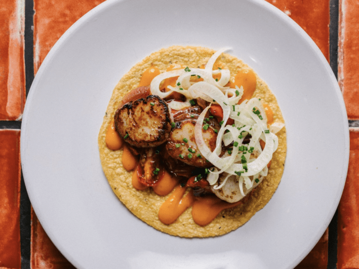 The scallop Taco from Holbox is pan seared and topped with chile x'catic sauce, caramelized onions, tomato & marinated fennel.