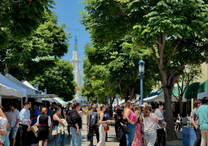 a crowd of people at a farmers market