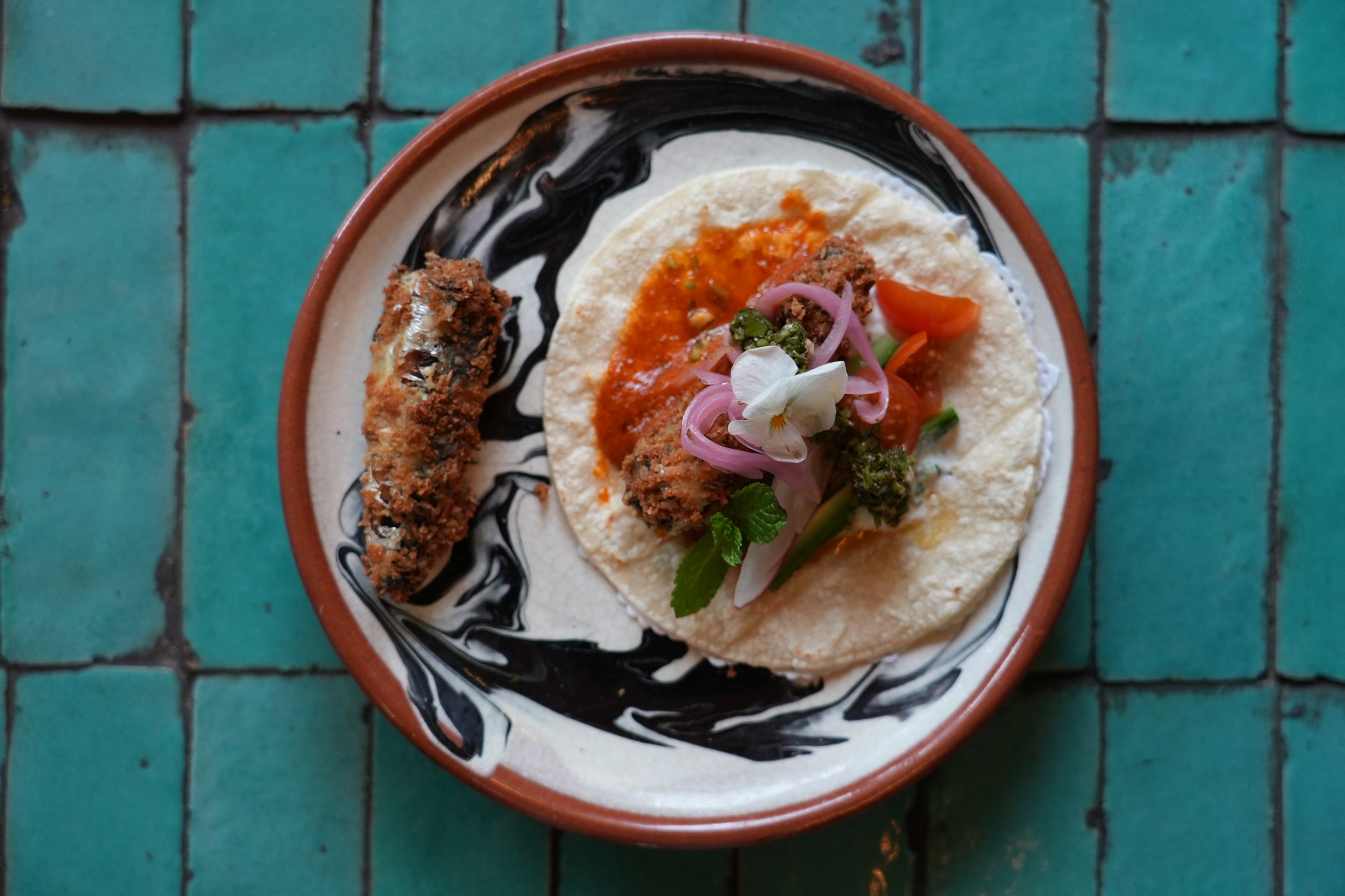 a plate of sardine tacos