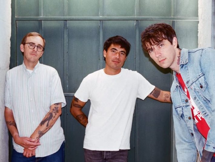 three men pose together