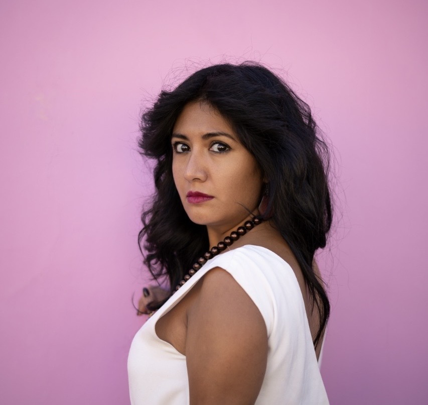 a woman looks into the camera