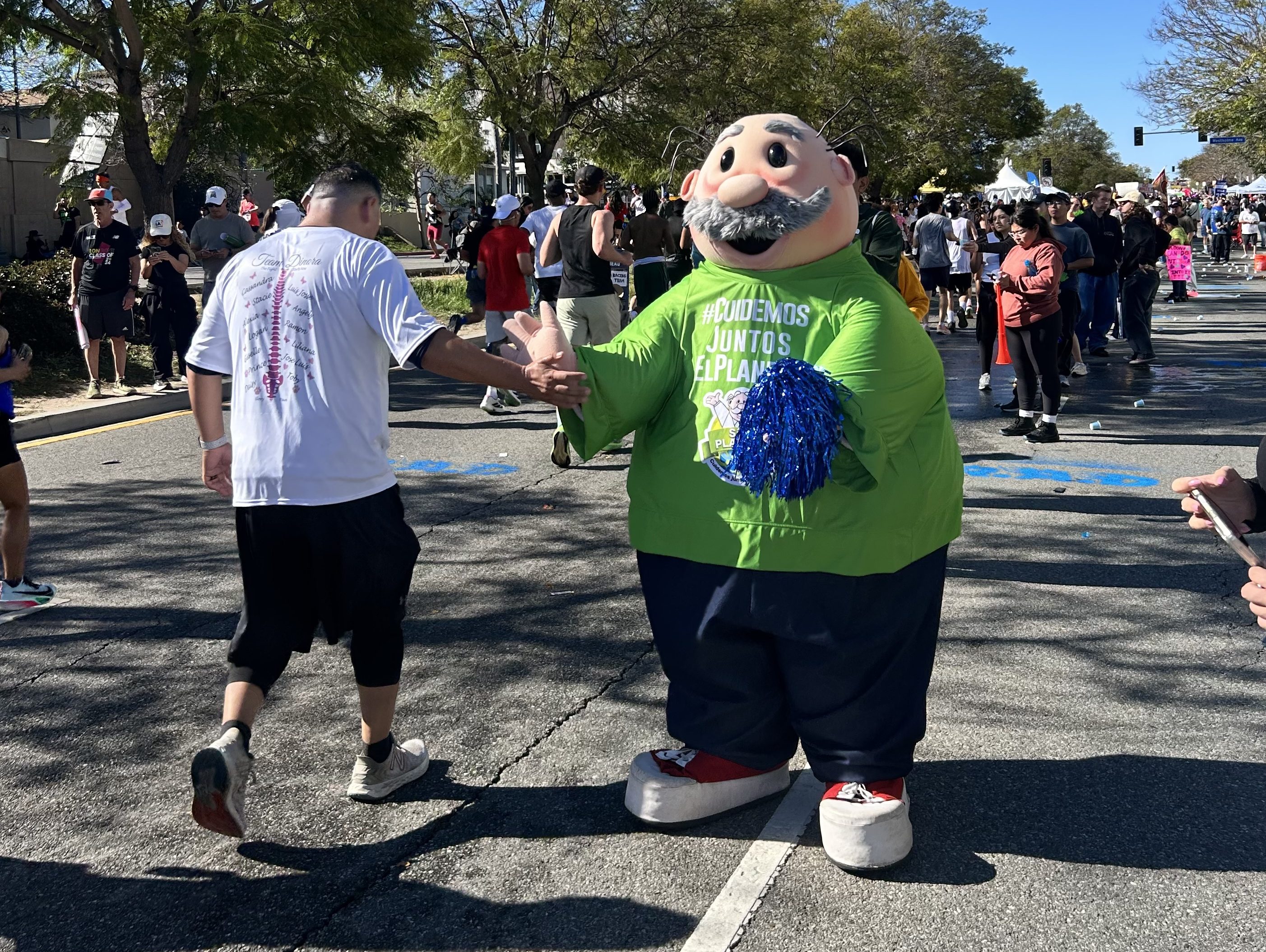 a mascot greeting a marathon runner