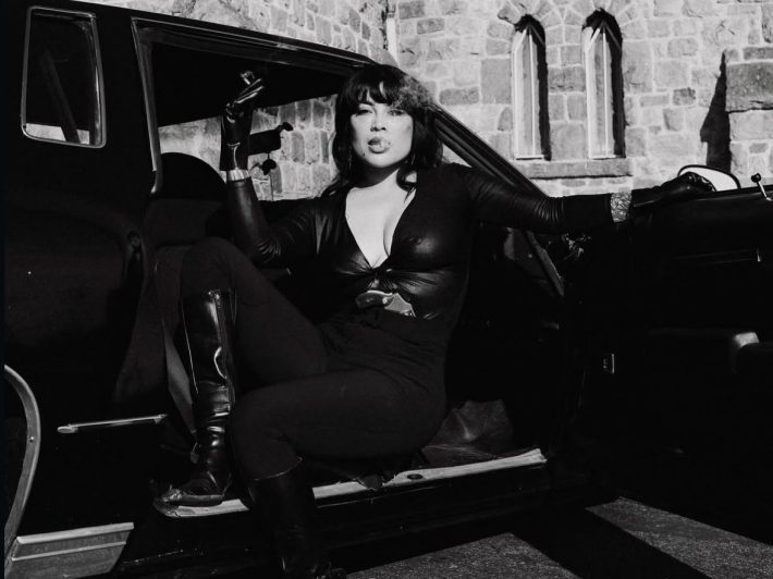 a woman posing in a car