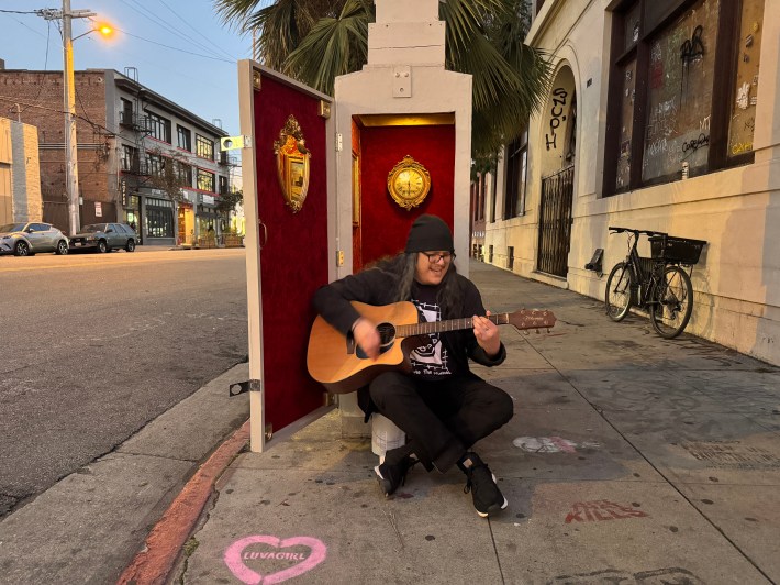 a man playing a guitar