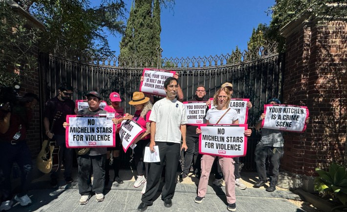 Jason Ignacio White stands with organizers with One Fair Wage in front of the entrance to the Noma L.A. popup at Paramour Estate.