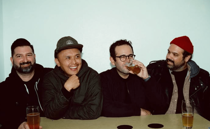 bandmates together at a a table