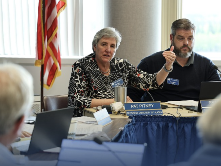 a woman speaks at a meeting