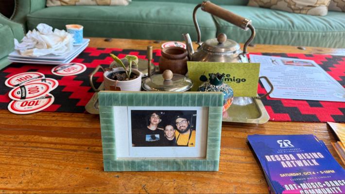 a framed photo of a woman and her sons on a table