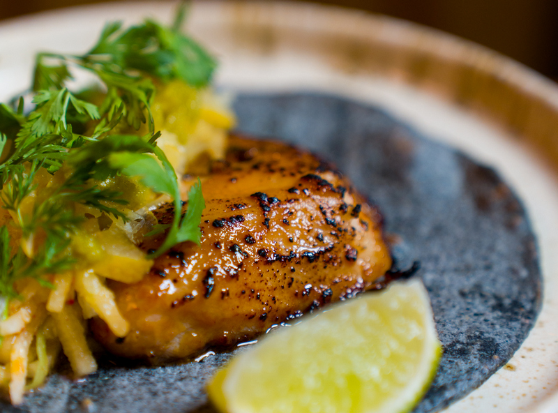 Black cod doenjang taco next to a slice of lime