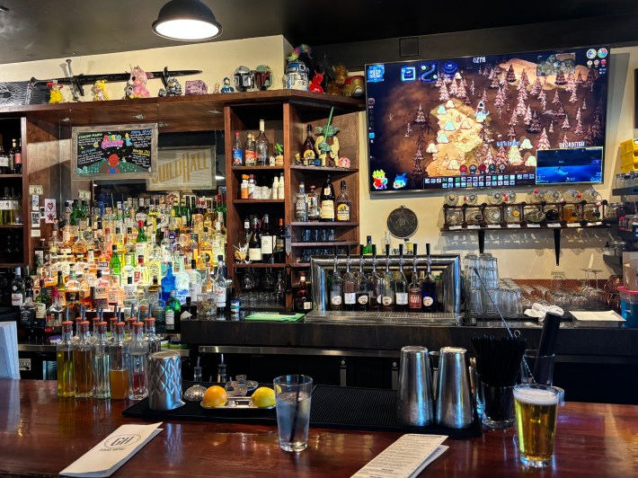inside of a bar with a game on TV