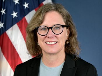 a woman's portrait in front of an American flag