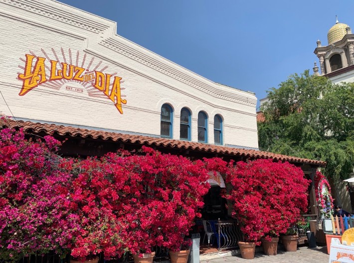 the exterior of a restaurant with the words "La Luz del Dia Est. 1915" painted on it