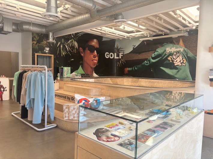 the interior of a fashion store with a skate bowl