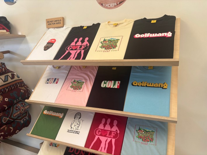 shelves of t-shirts on display