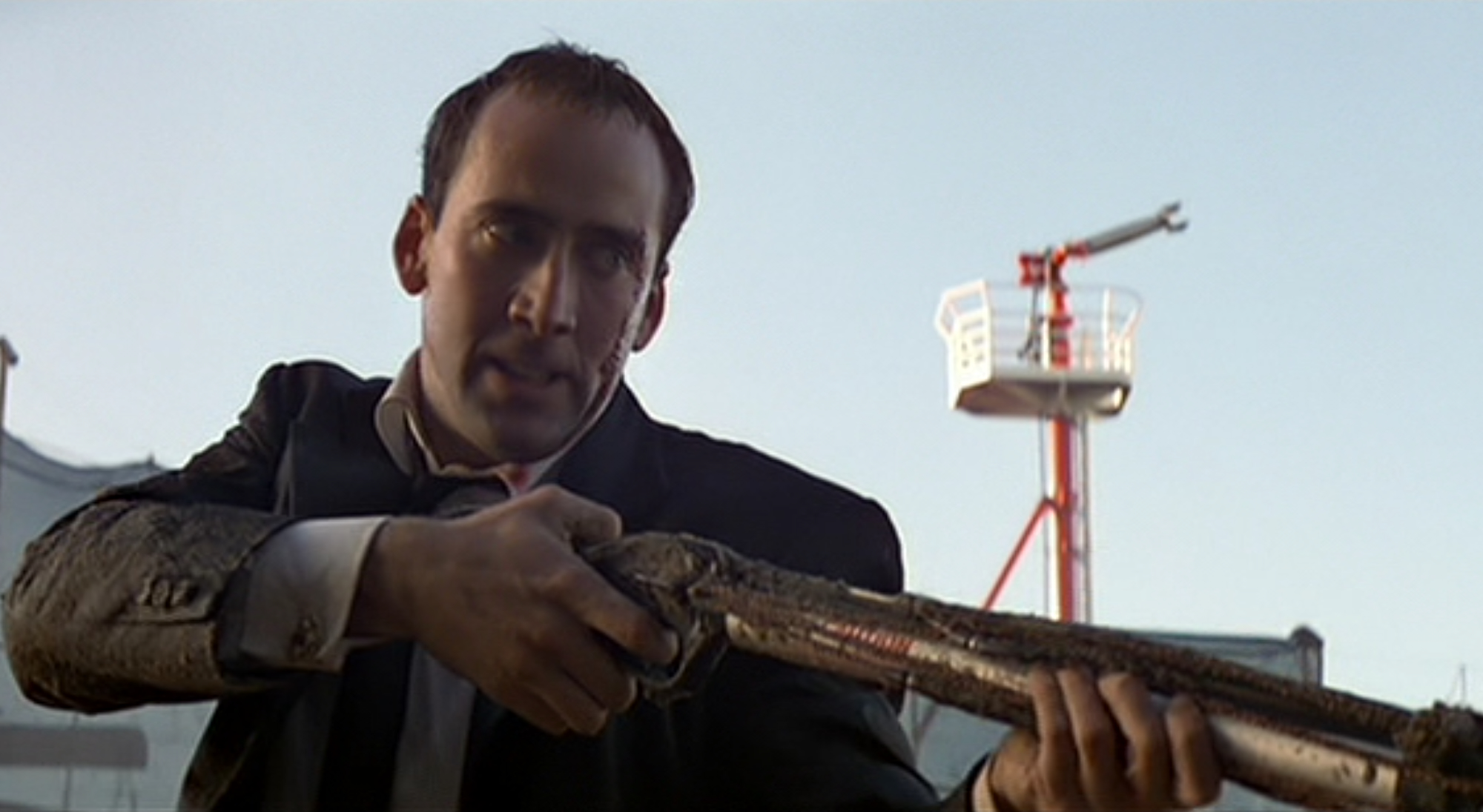 a man aims a long gun