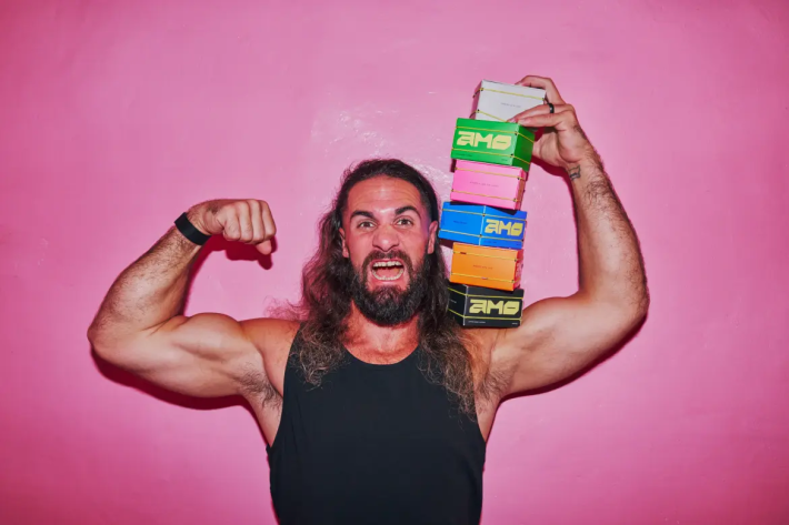 a man poses with boxes of coffee