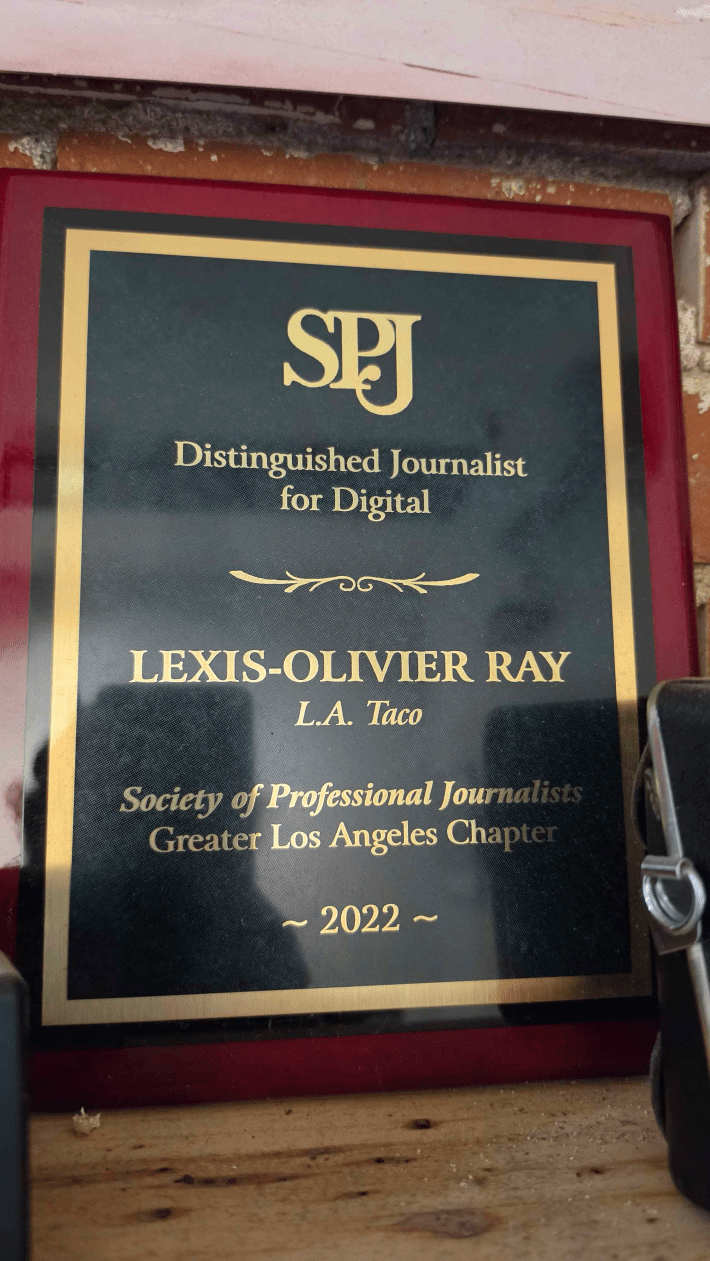 a plaque for "Distinguished Journalist for Digital" awarded to Lexis-Olivier Ray
