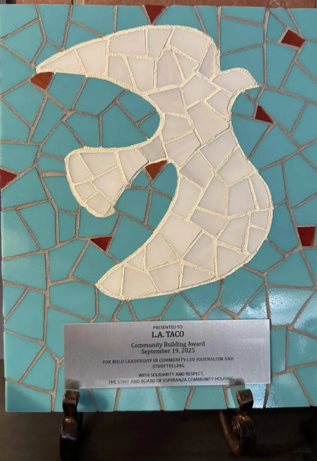 an award depicting a mosaic of a bird flying. the Community Building Award is presented to L.A. TACO by the Staff and Board of Esperanza Community Housing