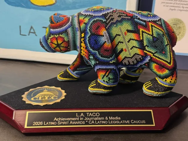 an award showing a beaded, colorful bear