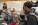an older man shakes the hand of a young student