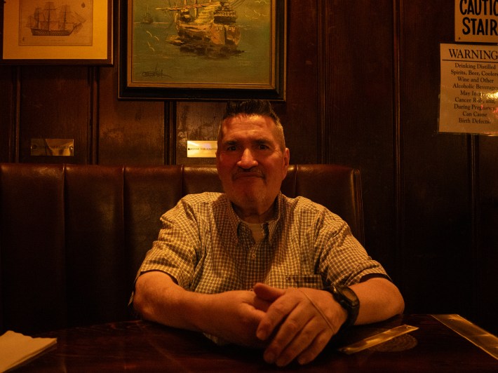 a man sits at a restaurant table