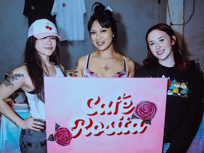 women pose with a sign