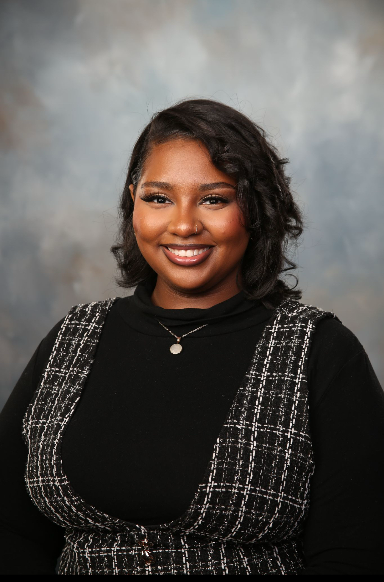 A young woman smiles in a headshot