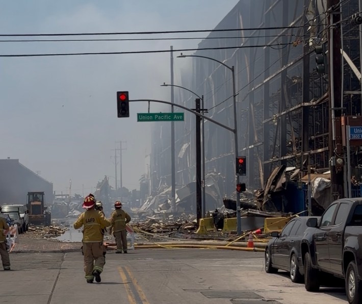 a hazy street with firefighters
