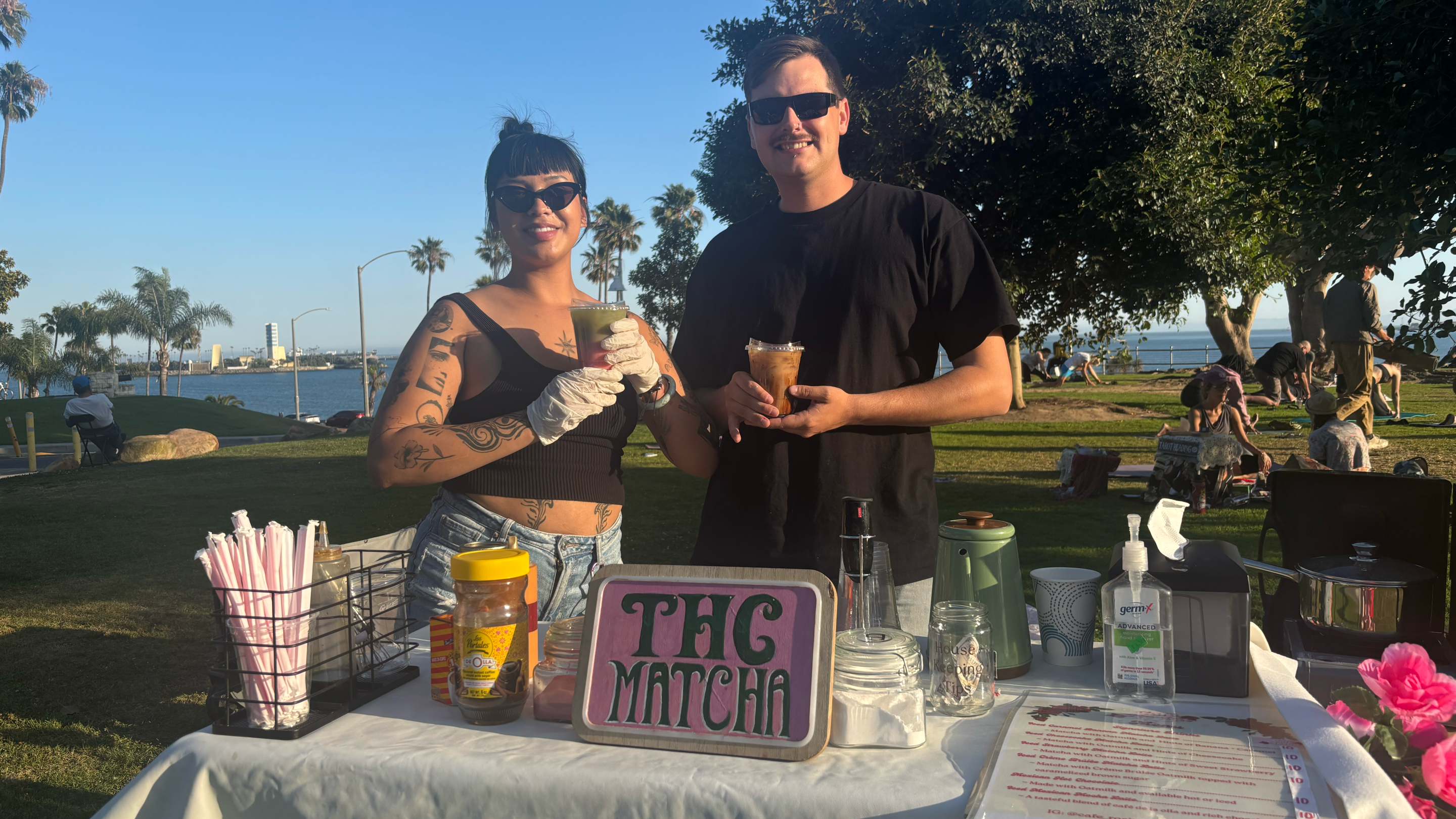a man and woman pose with drinks