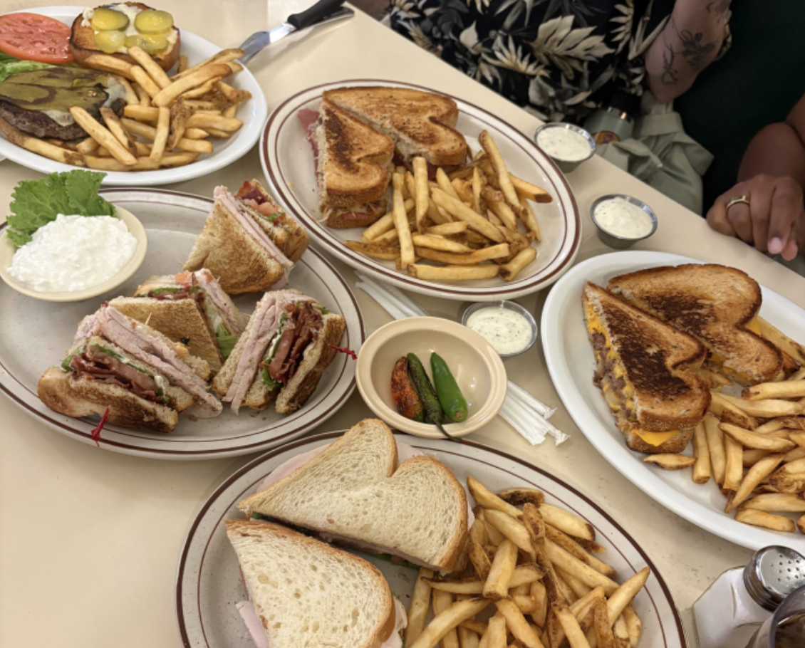 a table of sandwiches and fries