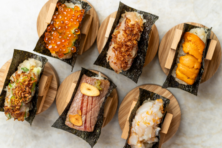 Six open faced handrolls with salmon roe, crispy onions, sea urchin, seared tuna, and scallops