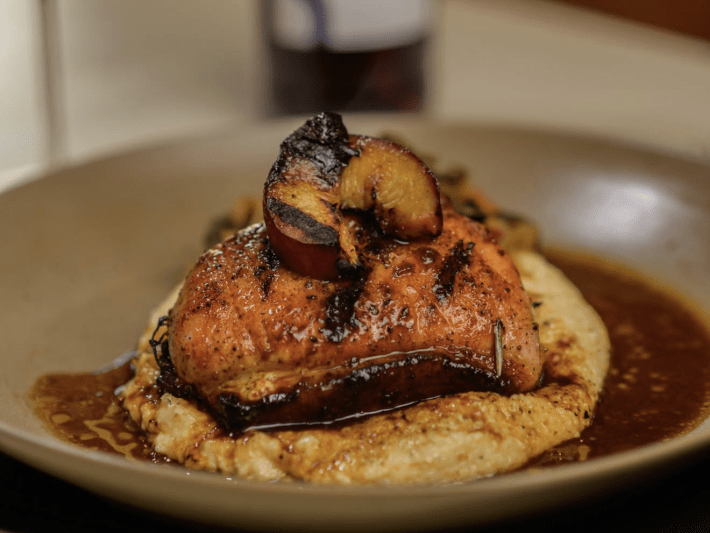 a pork chop atop mashed potatoes