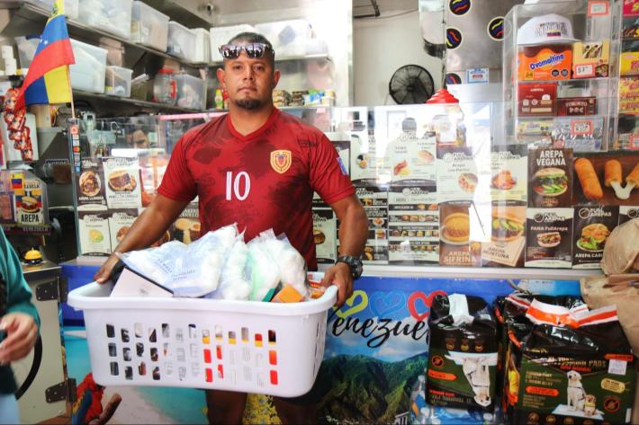 a man holding a basket of donations