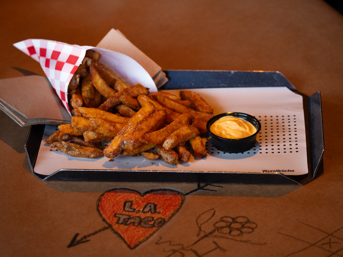 fires on a tray next to a heart that says "L.A. TACO"